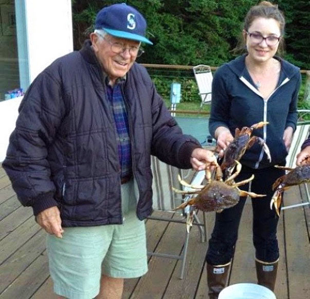 Zoe and her grandpa at their family home in the San Juans after a successful crabbing trip.