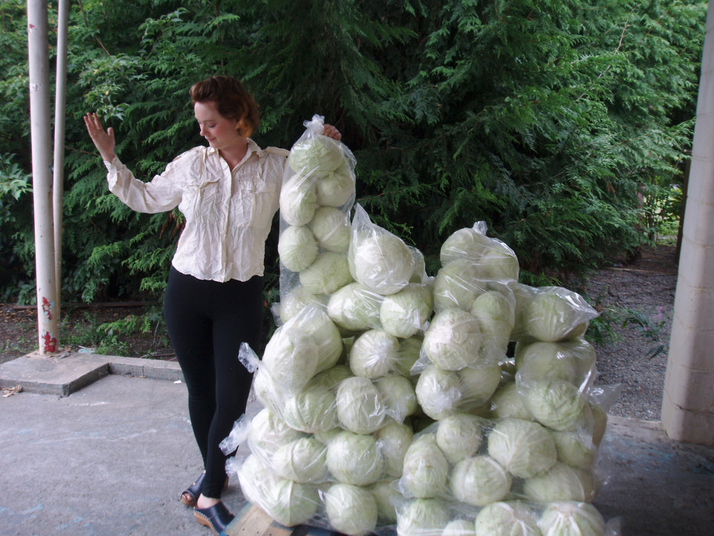 Our office admin, Whitney, with a pallet of cabbage