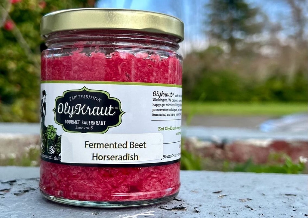 Jar of OlyKraut fermented beet horseradish on a table outdoors