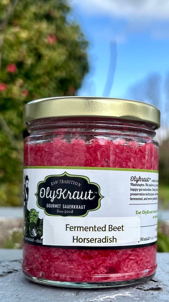 Jar of OlyKraut Fermented Beet Horseradish with a blurred natural background