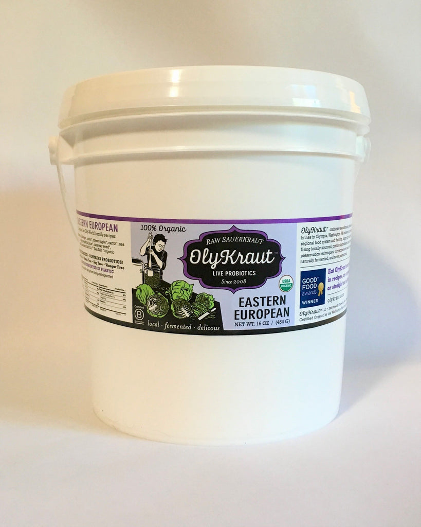 White container of OlyKraut Eastern European sauerkraut with a label on a white background